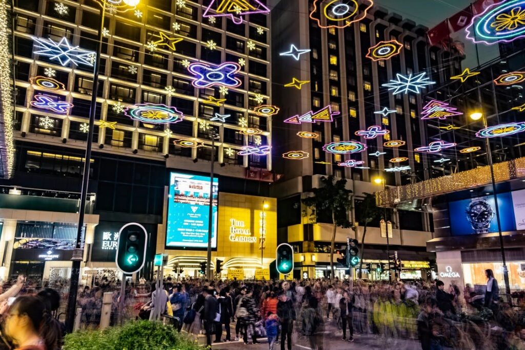 Digital screen displays advertising various brands outside a mall