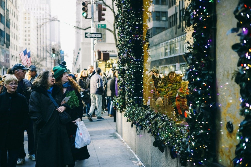 prospective customers engaging with a Christmas-themed indoor digital display